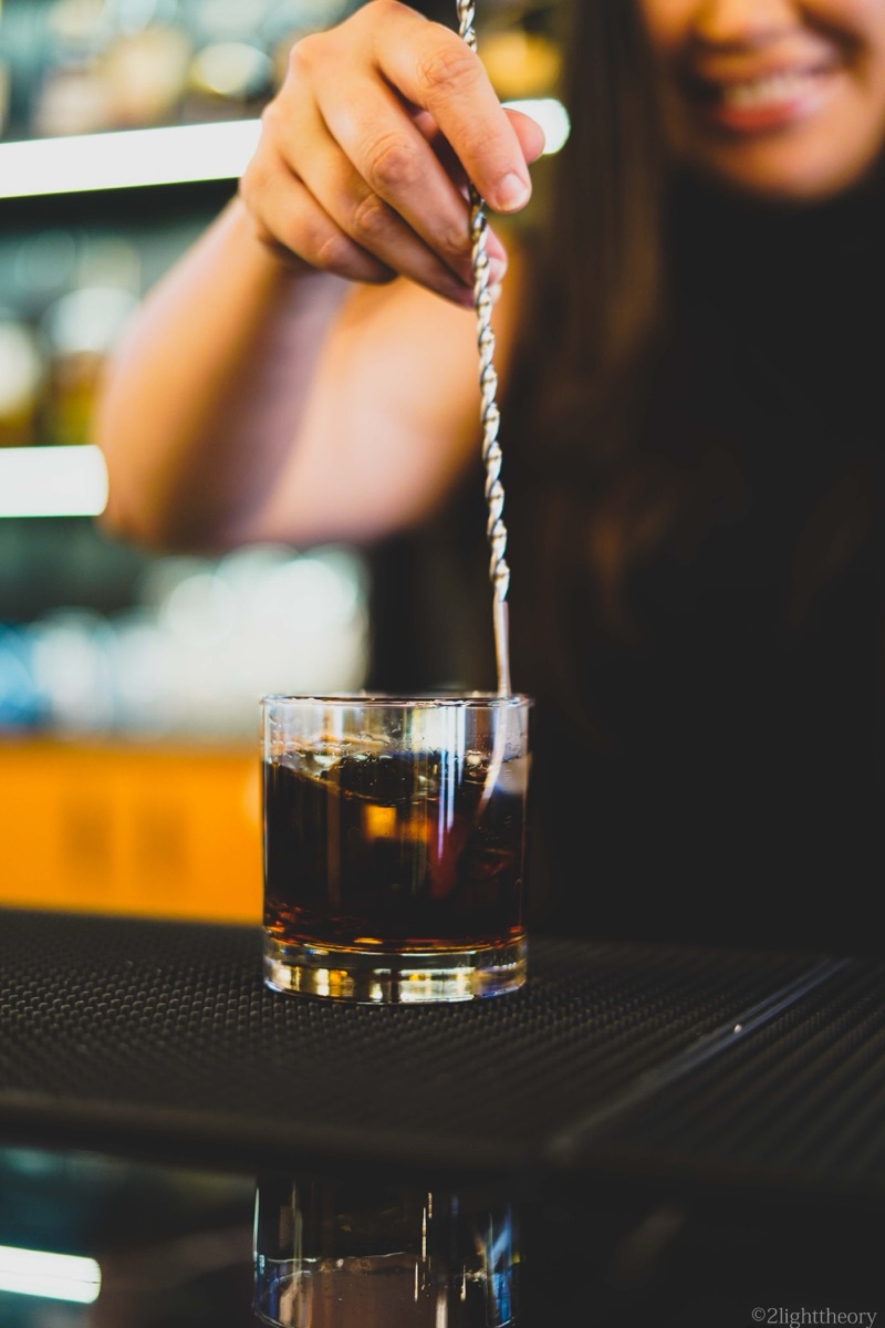 A drink being stirred at the bar
