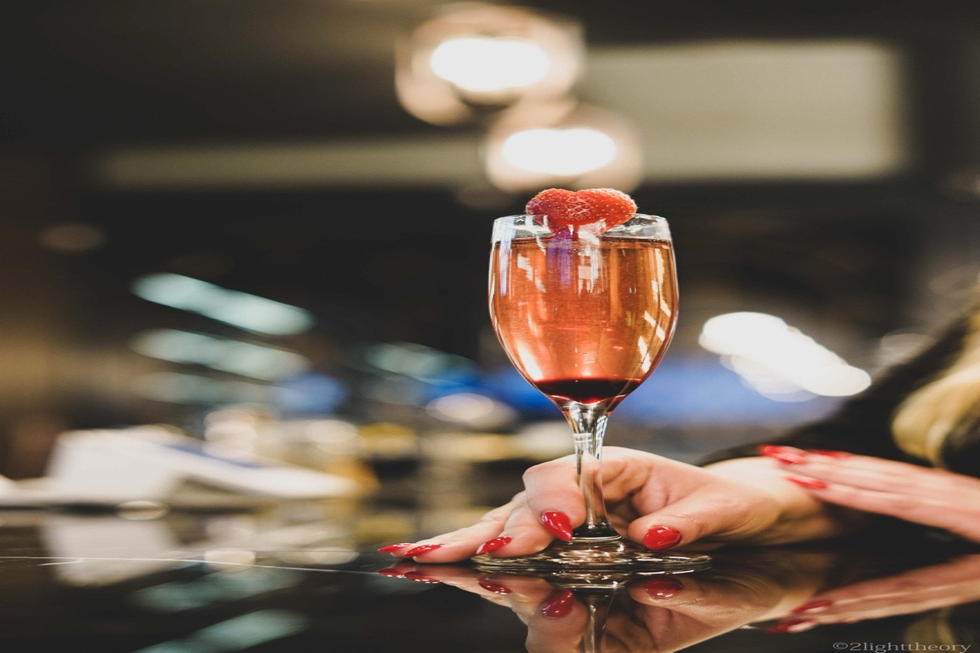 A cocktail on the bar top, reflected in the surface