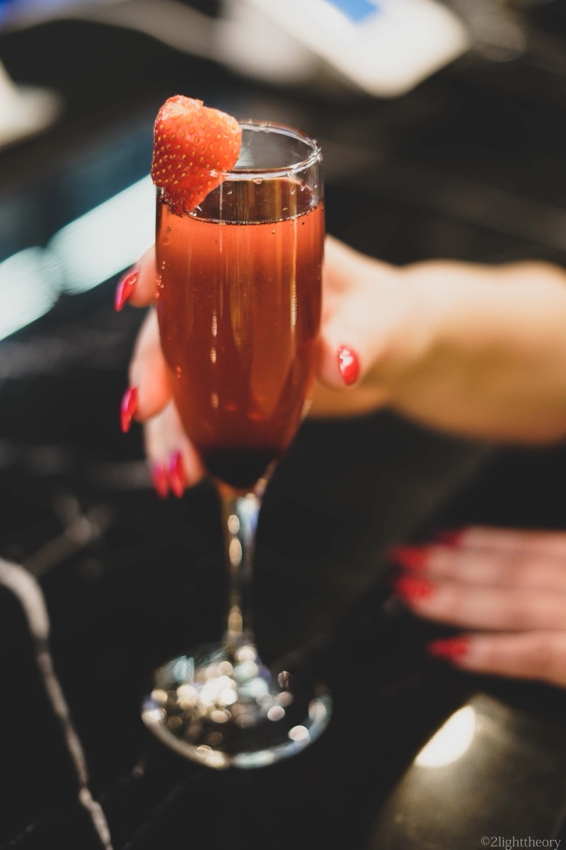 A cocktail held up in the lounge light