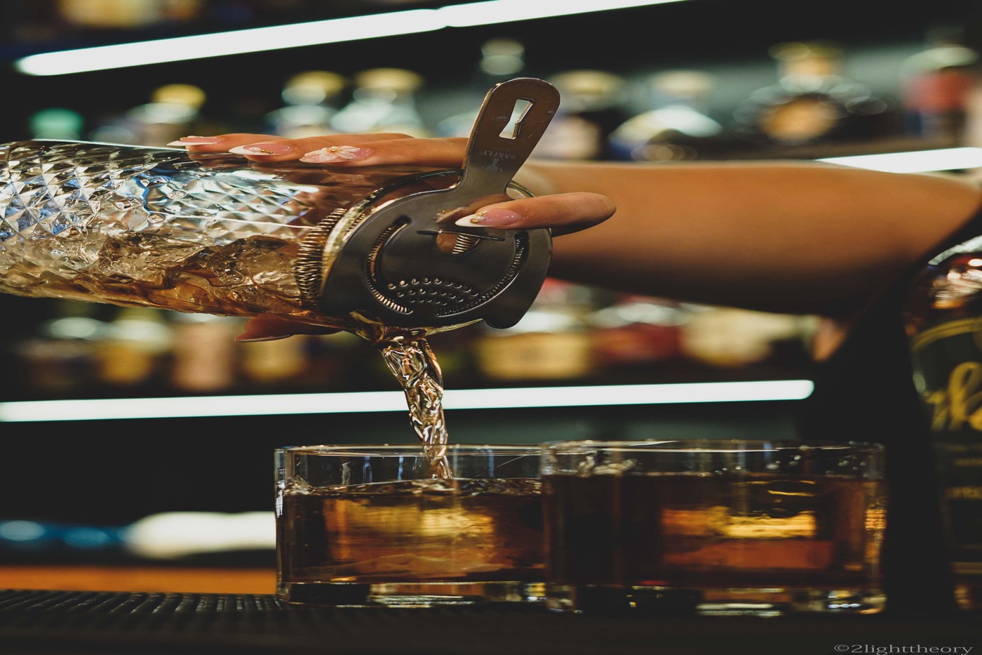 Pouring into two glasses over ice